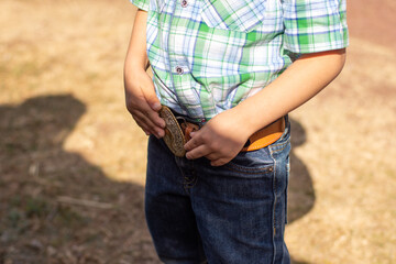 Close up of an unrecognizable child in cowboy clothes
