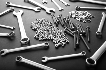 Metal nuts and bolts close up on black background