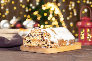 Christmas stollen on wooden background. Christmas Stollen cake and bokhe. Traditional hand made german christmas stollen