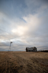 Abandoned and broken down old farms and homesteads with dark and ominous skies in Alberta, Canada