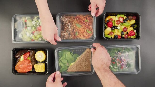 Closing take away meals top view, Food delivery in closed disposable containers, balanced nutrition. Fresh cooked portions in lunch boxes, vegetarian dishes. Healthy eating, diet. Catering service. 