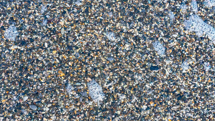 sea beach of small multi-colored pebbles as a natural background