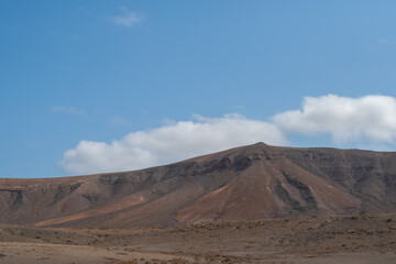 Fototapeta na wymiar Beautiful mountainous landscape. Deserted Mountains close to Puerto del Rosario in the inner part of Fuerteventura Island, Spain. Selective focus, blurred background.