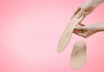Orthopedic insole isolated on a pink background. Medical insoles. Treatment and prevention of flat feet and foot diseases. Foot care, feet comfort. Wear comfortable shoes. Flat Feet Correction.