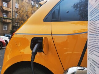 Yellow electric car on charger 