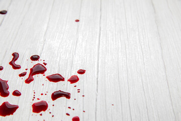 blood stains on white wooden background, dripped and splatterd blood with copy space, injury wound,...