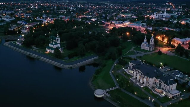 Scenic general aerial view of lighted Russian town of Uglich on banks of Volga River on summer evening, Yaroslavl Oblast. High quality 4k footage