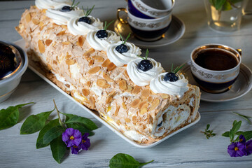 Bizet roll with whipped cream, garnished with nuts and berries.