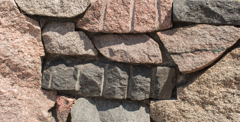 A wall of large granite uncut stones