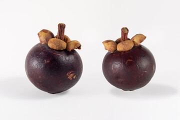 Two Mangosteens on a white background.