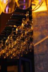 Lot of empty clean glasses in bar. Clean wine glasses prepared and hung on bar at restaurant