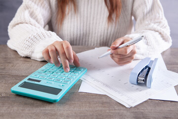 young woman counting on a calculator