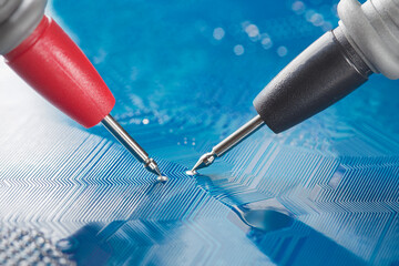Measuring electronic signal from component on the PCB. Electronics repair and digital technology.