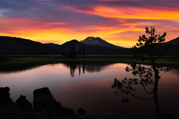 Beautiful peaceful vibrant sunrise over Broken Top and Sparks Lake