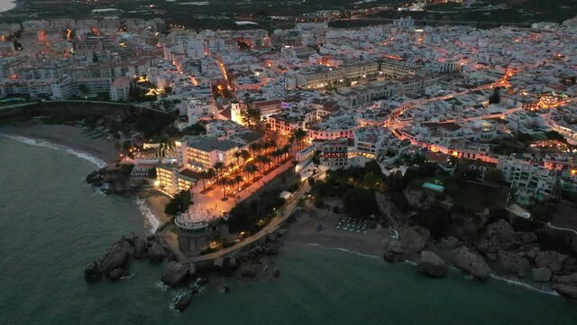 Aerial view of Nerja city with coastline in province of Malaga at night, Andalusia, southern Spain. High quality 4k footage