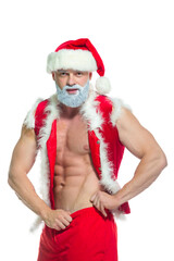 Christmas. Portrait of muscular sexy strong athlete in Santa Claus costume with gray beard posing showing his abs isolated on white background