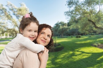 Fototapeta premium Happy mother having fun with her daughter outdoor