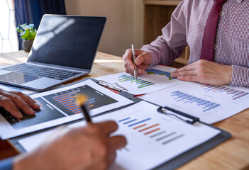 Marketing analysis two business people discussing Financial charts to analyze profits, investment results and company financial performance, investment development consulting.