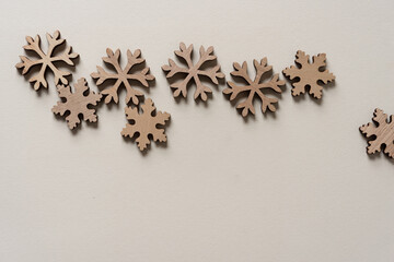 holiday background with wooden snowflakes