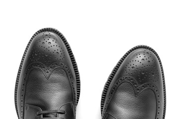 Close up of a pair of black leather shoes, Full brogue, luxury men's shoes, fashion, casual boots, winter boots, white isolated background, product photography 