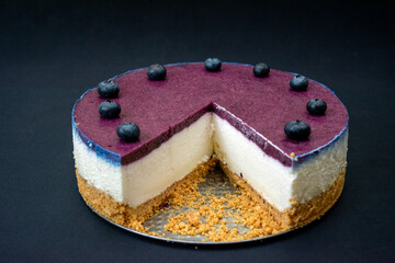Unbaked blueberry cheesecake on an empty space with close ups 