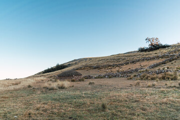 hut and cabin on a mountain in the Andes of Peru in a sunset with a blue sky surrounded by green vegetation and trees