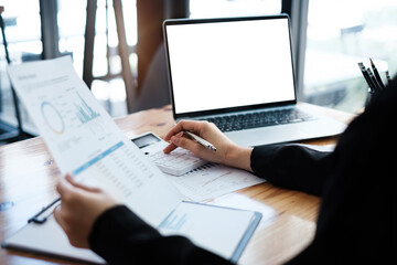 Fototapeta premium Business woman or Accountant hand holding pen and using calculator to analyze company budget, Account or saving money or insurance concept.