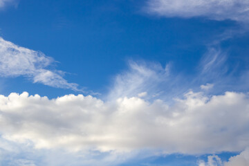 White fluffy clouds against a blue sky. Air background, place for text