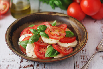 A bowl with traditional Italian caprese salad	