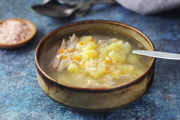 A bowl with chicken soup with pasta