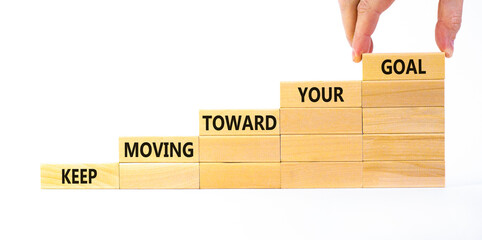 Keep moving toward your goal symbol. Wooden blocks with words Keep moving toward your goal....