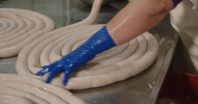 Pork intestines making sausages are filled with a mass of minced meat and spices