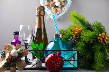 New Year's holiday gift. Champagne bottle green tree and sweets