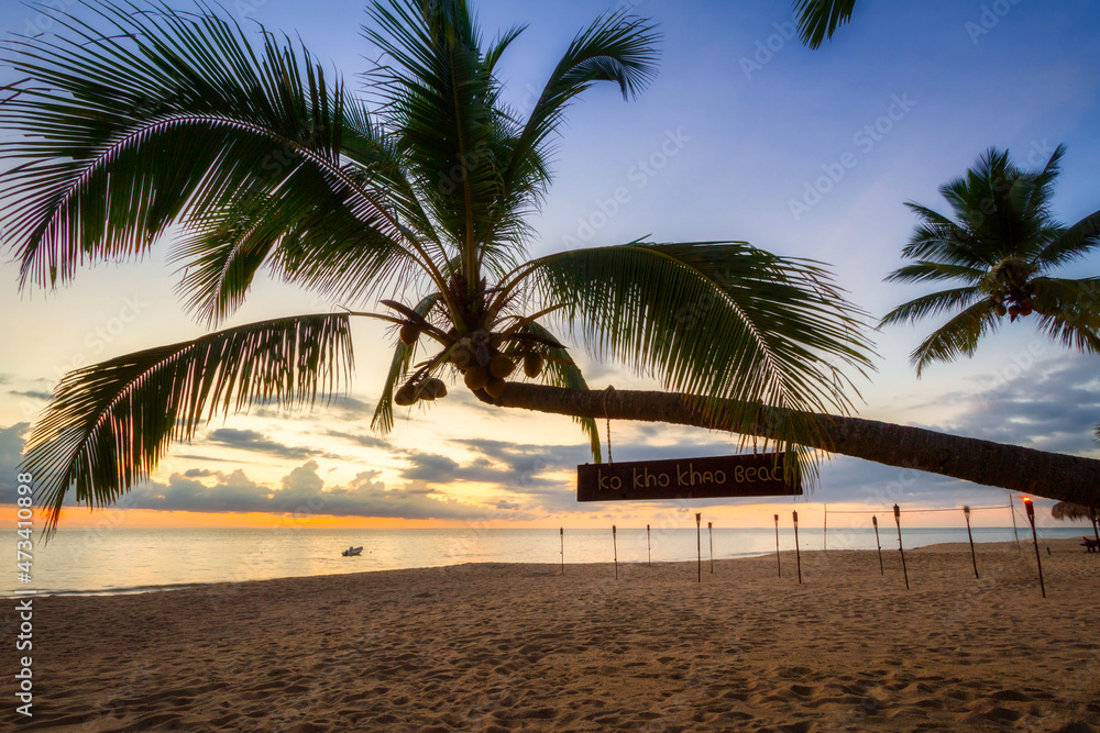 Wall mural beautiful sunset on the beach of ko kho khao island with palm trees, thailand