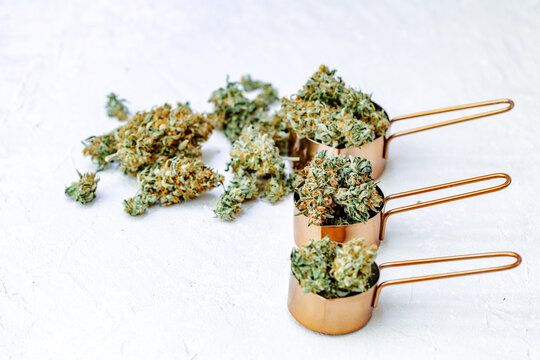 Marijuana buds, leaves and resin, flat lat, top view. Cannabis flowers on grey background. Hemp recreation, home pastime, legalization concept.