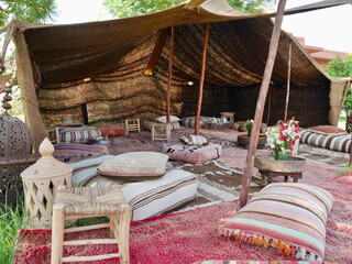 Beautiful lounge area (Bedouin tent) in lush tropical garden. Marrakech, Morocco.