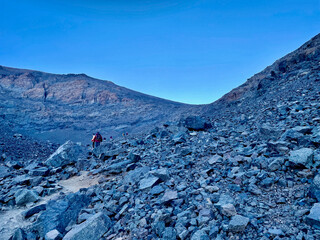 Hikers descending from Djebel Toubkal, North Africa's highest mountain, at dawn. Morocco.
