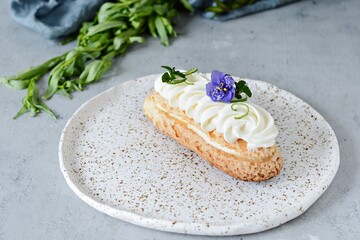  French eclair with fruit and chocolate coconut and gentle mousse. Delicious dessert. Cake in the...
