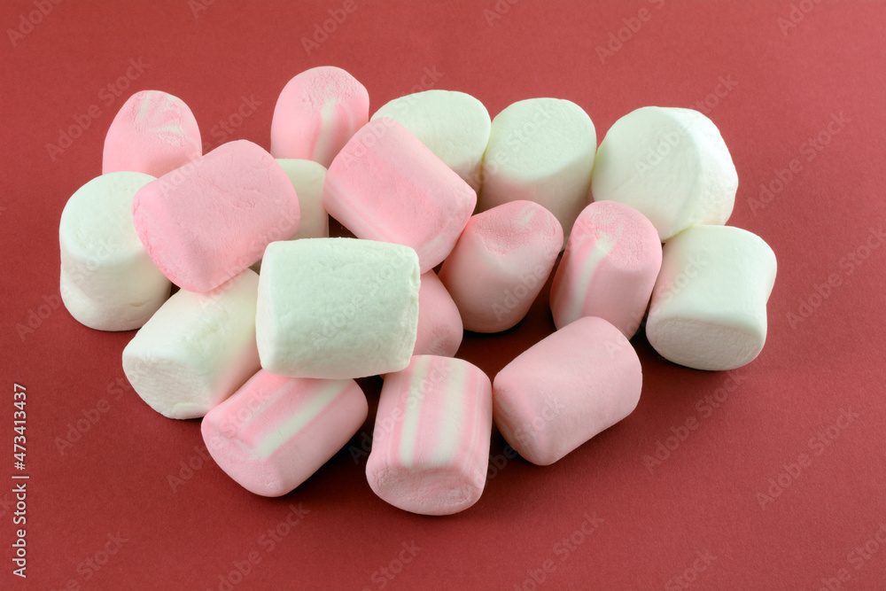 Wall mural Jumbo marshmallows and jumbo strawberry marshmallows on red background