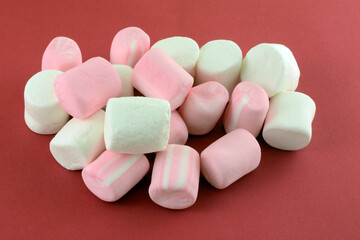Jumbo marshmallows and jumbo strawberry marshmallows on red background