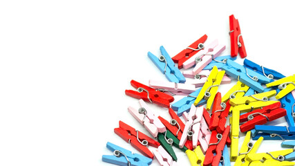 Colorful clothes pins on paper sheet background