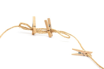 Clothes pins on craft rope isolated on white background