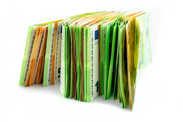 A macro photo of a European Union currency, stacked on a pile of 50 and 100 euro banknotes,...
