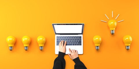 Person using a laptop computer with light bulbs from above