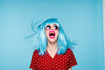 emotional glamorous woman on blue wig fashion glasses posing