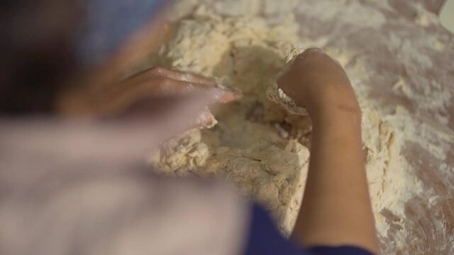 latina woman preparing dough for tortillas