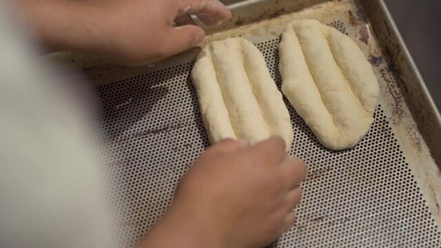 Mexican artisan preparing bread for baking