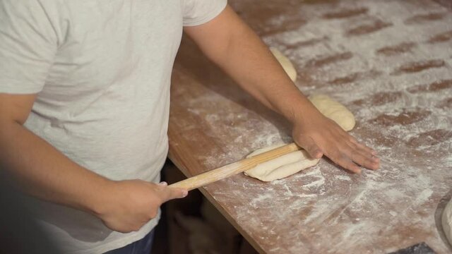 unrecognizable man molding mexican bread