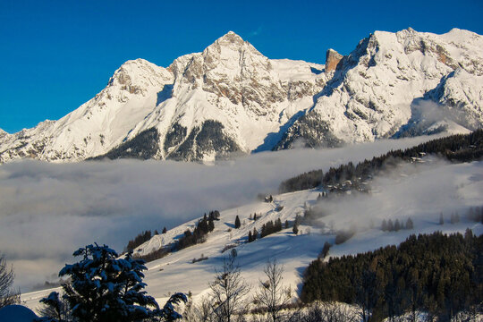 Winter landscape, stunning mountain range, snowy trees and blue sky at Maria Alm, Hinterthal in Austria