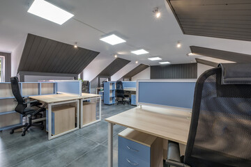 Fototapeta na wymiar interior in empty work mansard room in modern office or coworking